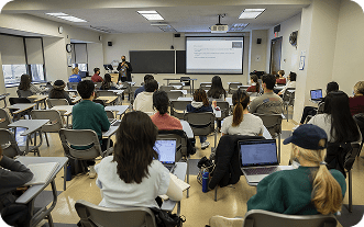 Students attentively listening to a lecture in a classroom.