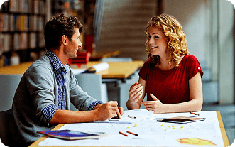 Two colleagues discussing ideas during a meeting.